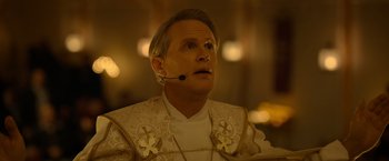 Movie still from “The Unholy” (2021), directed by Evan Spiliotopoulos – A man with a headset in his ears; Close Up shot, Low angle