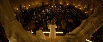 Movie still from “The Unholy” (2021), directed by Evan Spiliotopoulos – A crowd of people gathered in front of an altar; Wide shot, High angle