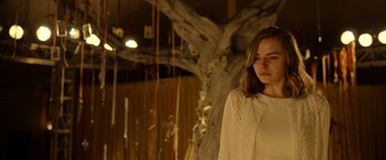 Movie still from “The Unholy” (2021), directed by Evan Spiliotopoulos – A woman standing in front of a tree; Medium shot, Low angle