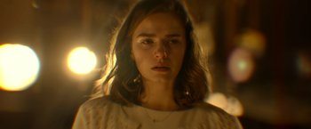 Movie still from “The Unholy” (2021), directed by Evan Spiliotopoulos – A young woman with long brown hair stares at the camera; Close Up shot, Low angle