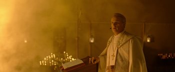Movie still from “The Unholy” (2021), directed by Evan Spiliotopoulos – A priest standing in front of a lectern in a church; Medium shot, Low angle