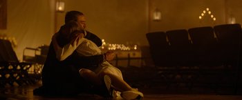 Movie still from “The Unholy” (2021), directed by Evan Spiliotopoulos – A man and a woman sitting on the ground at night; Medium shot, Over the shoulder angle