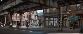 Movie still from “The Untouchables” (1987), directed by Brian De Palma – An old photo of a city street with buildings; Extreme Wide shot, High angle