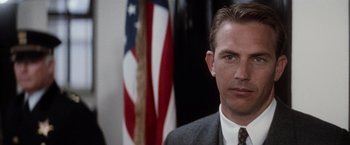 Movie still from “The Untouchables” (1987), directed by Brian De Palma – A person wearing a suit and tie; Close Up shot, Low angle