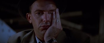 Movie still from “The Untouchables” (1987), directed by Brian De Palma – A person wearing a suit and a hat; Close Up shot, Over the shoulder angle