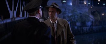 Movie still from “The Untouchables” (1987), directed by Brian De Palma – A man in a hat and a tie talking to another man in a hat and a tie; Close Up shot, Over the shoulder angle