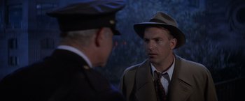 Movie still from “The Untouchables” (1987), directed by Brian De Palma – A man wearing a hat and a suit talking to another man wearing a hat; Close Up shot, Over the shoulder angle