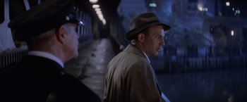 Movie still from “The Untouchables” (1987), directed by Brian De Palma – A man wearing a hat standing next to another man in a tunnel; Close Up shot, Over the shoulder angle