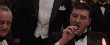 Movie still from “The Untouchables” (1987), directed by Brian De Palma – A man in a tuxedo talking on a cell phone; Close Up shot, Low angle