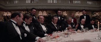 Movie still from “The Untouchables” (1987), directed by Brian De Palma – A group of men sitting at a dinner table in tuxedos; Medium shot, Low angle