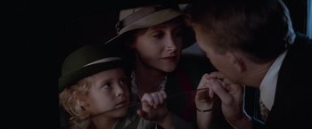 Movie still from “The Untouchables” (1987), directed by Brian De Palma – A woman and two children are sitting in a car; Close Up shot, Over the shoulder angle
