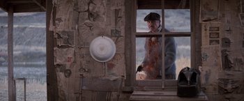Movie still from “The Untouchables” (1987), directed by Brian De Palma – An old man looking out of a broken window; Medium shot, High angle