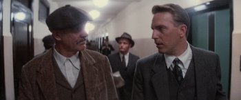 Movie still from “The Untouchables” (1987), directed by Brian De Palma – A group of men standing next to each other in a hallway; Close Up shot, Over the shoulder angle