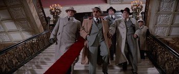 Movie still from “The Untouchables” (1987), directed by Brian De Palma – A group of men walking up a set of stairs; Wide shot, Low angle
