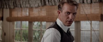 Movie still from “The Untouchables” (1987), directed by Brian De Palma – A person wearing a suit and tie; Close Up shot, Over the shoulder angle