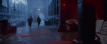 Movie still from “The Untouchables” (1987), directed by Brian De Palma – Two people walking down a street in the rain; Extreme Wide shot, High angle