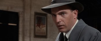 Movie still from “The Untouchables” (1987), directed by Brian De Palma – A person wearing a suit and a hat; Close Up shot, Over the shoulder angle