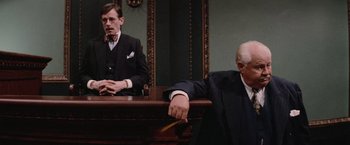 Movie still from “The Untouchables” (1987), directed by Brian De Palma – A man in a suit and tie sitting in front of a mirror; Medium shot, Over the shoulder angle