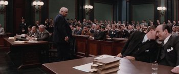 Movie still from “The Untouchables” (1987), directed by Brian De Palma – A crowd of people sitting in a court room; Wide shot, Over the shoulder angle
