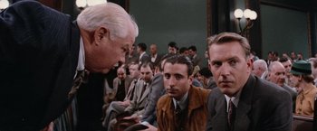 Movie still from “The Untouchables” (1987), directed by Brian De Palma – An older man talking to a group of men; Close Up shot, Over the shoulder angle