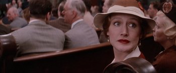 Movie still from “The Untouchables” (1987), directed by Brian De Palma – A woman with a hat sitting in a crowd of people; Close Up shot, Over the shoulder angle