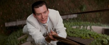 Movie still from “The Untouchables” (1987), directed by Brian De Palma – A man in a suit and tie pulling a rope; Close Up shot, Low angle
