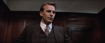 Movie still from “The Untouchables” (1987), directed by Brian De Palma – A person wearing a suit and tie; Close Up shot, Low angle