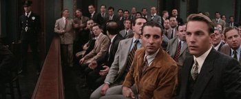 Movie still from “The Untouchables” (1987), directed by Brian De Palma – A group of men in suits and ties sitting next to each other; Medium shot, Over the shoulder angle
