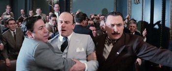 Movie still from “The Untouchables” (1987), directed by Brian De Palma – A group of men standing next to each other in a room; Medium shot, Over the shoulder angle