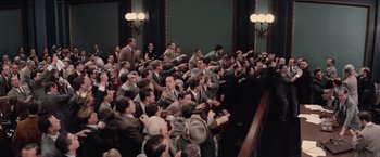 Movie still from “The Untouchables” (1987), directed by Brian De Palma – A group of men in suits sitting in front of a crowd; Extreme Wide shot, Overhead angle