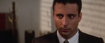 Movie still from “The Untouchables” (1987), directed by Brian De Palma – A person wearing a suit and tie; Close Up shot, Low angle