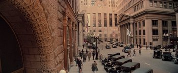 Movie still from “The Untouchables” (1987), directed by Brian De Palma – A group of people walking down a sidewalk; Extreme Wide shot, High angle