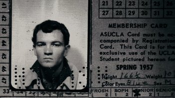 Movie still from “The Velvet Underground” (2021), directed by Todd Haynes – An old photo of a young man's id card; Extreme Close Up shot, Overhead angle