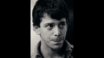 Movie still from “The Velvet Underground” (2021), directed by Todd Haynes – Black and white photograph of a young man's face; Close Up shot, Low angle