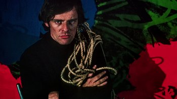 Movie still from “The Velvet Underground” (2021), directed by Todd Haynes – A man holding a bunch of ropes in his hands; Close Up shot, Low angle