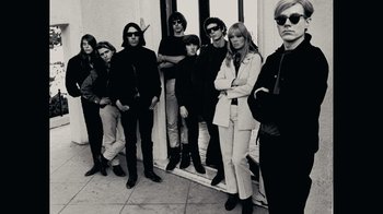 Movie still from “The Velvet Underground” (2021), directed by Todd Haynes – A black and white photo of a group of people standing next to each other; Wide shot, Low angle