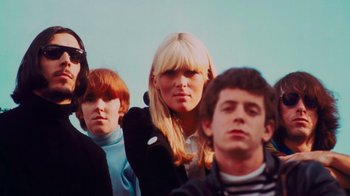 Movie still from “The Velvet Underground” (2021), directed by Todd Haynes – A group of people standing next to each other; Medium shot, Low angle
