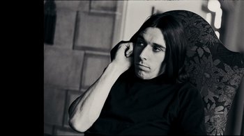 Movie still from “The Velvet Underground” (2021), directed by Todd Haynes – Black and white photograph of a man with long black hair; Close Up shot, Low angle