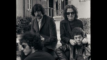 Movie still from “The Velvet Underground” (2021), directed by Todd Haynes – A black and white photo of a group of people; Medium shot, Low angle