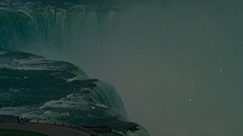 Movie still from “The Velvet Underground” (2021), directed by Todd Haynes – A man standing on a cliff looking at a waterfall; Extreme Wide shot, High angle