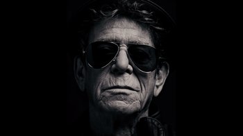 Movie still from “The Velvet Underground” (2021), directed by Todd Haynes – A black and white photo of a man wearing sunglasses; Close Up shot, Low angle