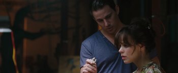 Movie still from “The Vow” (2012), directed by Michael Sucsy – A man and a woman looking at something in a jar; Close Up shot, Over the shoulder angle