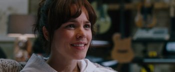 Movie still from “The Vow” (2012), directed by Michael Sucsy – A person smiling with a guitar in the background; Close Up shot, Over the shoulder angle