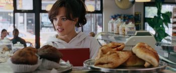 Movie still from “The Vow” (2012), directed by Michael Sucsy – A woman sitting in front of a plate of food at a restaurant; Close Up shot, Over the shoulder angle