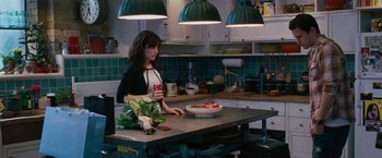Movie still from “The Vow” (2012), directed by Michael Sucsy – A woman standing in a kitchen with a bowl of fruit; Medium shot, Over the shoulder angle