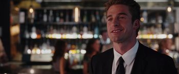 Movie still from “The Vow” (2012), directed by Michael Sucsy – A man wearing a suit and tie in front of a bar; Close Up shot, Over the shoulder angle
