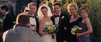 Movie still from “The Vow” (2012), directed by Michael Sucsy – A group of people standing next to each other holding a bouquet; Medium shot, Over the shoulder angle
