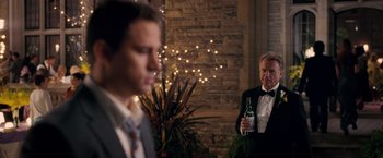 Movie still from “The Vow” (2012), directed by Michael Sucsy – A man in a tuxedo holding a bottle of beer; Medium shot, Over the shoulder angle