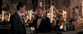 Movie still from “The Vow” (2012), directed by Michael Sucsy – A man in a tuxedo holding a glass of wine; Medium shot, Over the shoulder angle
