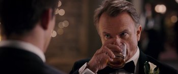 Movie still from “The Vow” (2012), directed by Michael Sucsy – A man in a tuxedo drinking a glass of whiskey; Close Up shot, Over the shoulder angle